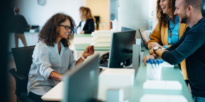 A woman works on paperwork in an office.