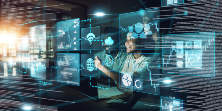 Trio of black tech workers smile while looking at an overlay of futuristic IT charts, icons and buttons.