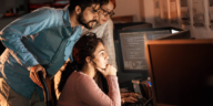 3 people looking at computer